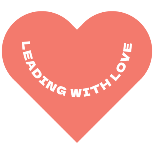 light red heart with white lettering that says "leading with love"